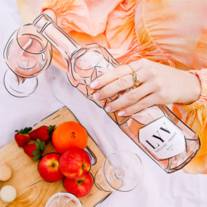 Main tenant une bouteille de LYV Rosé entourée de fruits frais (fraises, pommes, orange) sur une planche en bois, avec des verres à vin sur une nappe blanche. Style artistique avec contours dessinés à la main.